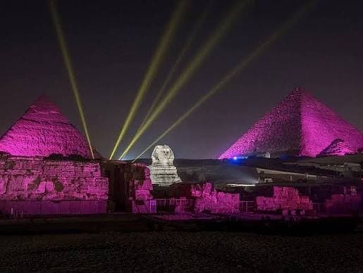 The Experience: As night falls, the Giza Plateau is bathed in vibrant, shifting colored floodlights and laser projections. Accompanied by a dramatic musical score, a booming audio narration brings the monuments to life.   