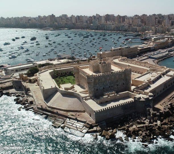 Citadel of Qaitbay & The Sunken Pharos: Home of the Ancient Wonder Journey to the legendary shores of Alexandria's ancient Pharos Island, once home to the majestic Lighthouse of Alexandria—one of the Seven Wonders of the Ancient World. Though a massive part of the historic island and ancient wonder tragically sank beneath the Mediterranean waves, its timeless legacy lives on. Today, the imposing Citadel of Qaitbay stands proudly right on the edge, built directly from the salvaged ruins and stones of the fallen ancient marvel. 