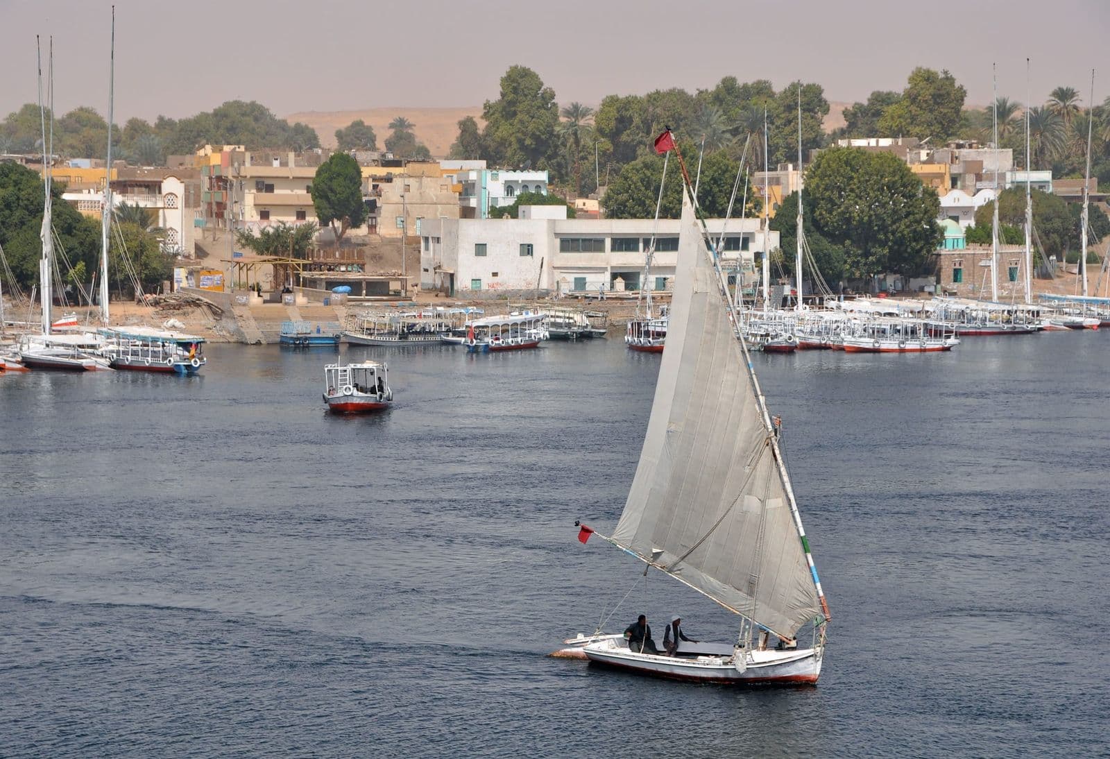 A white-sailed felucca on the Nile at Aswan