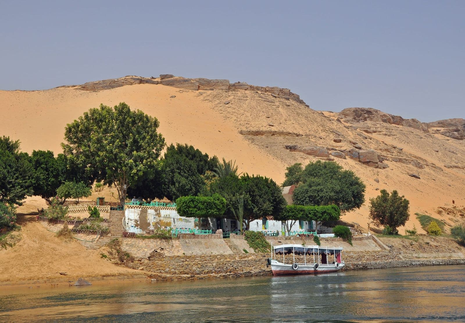 Golden dunes and green gardens on the Nile's west bank at Aswan