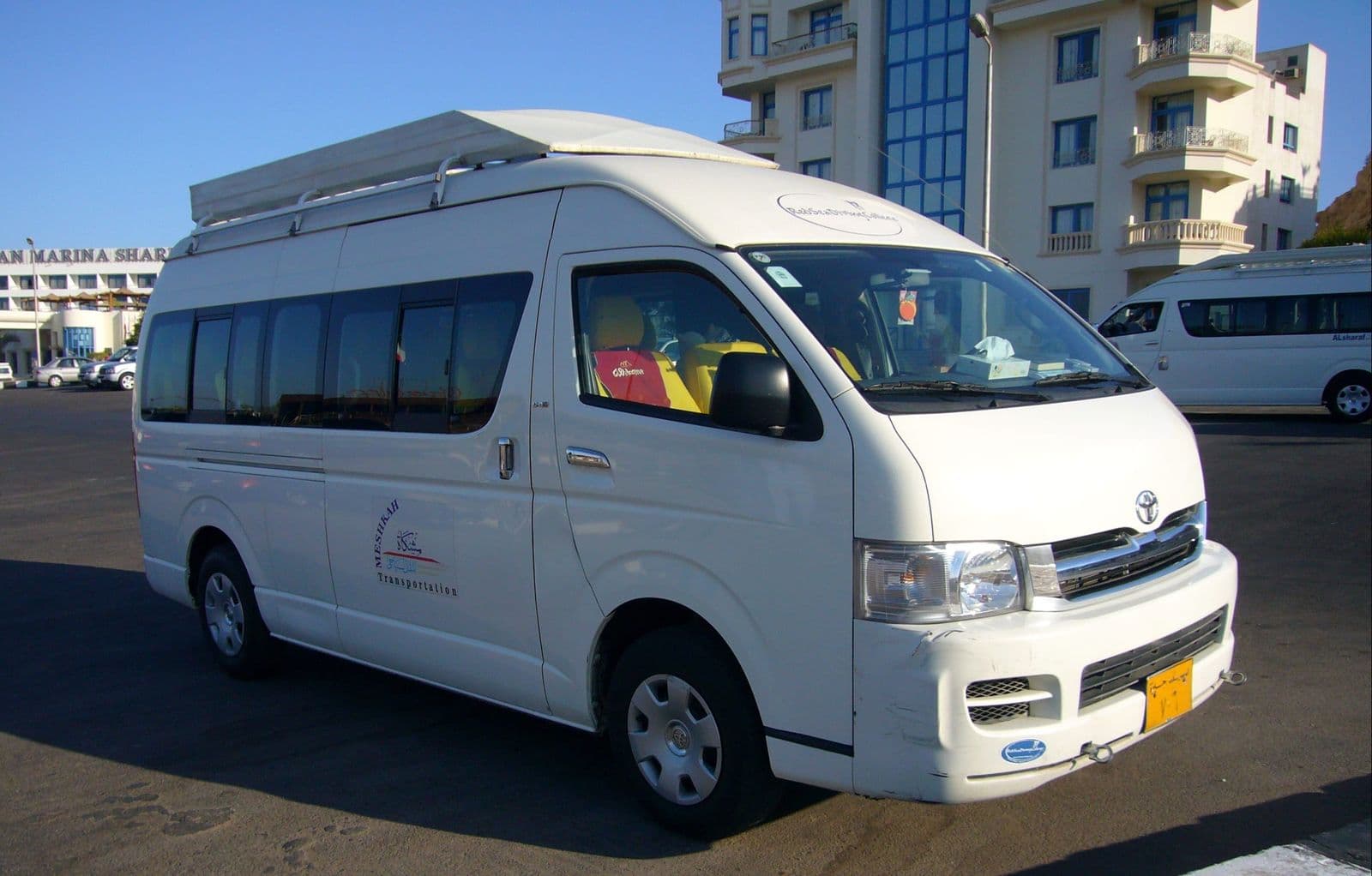 A white Toyota HiAce minivan of the kind used for private transfers in Egypt