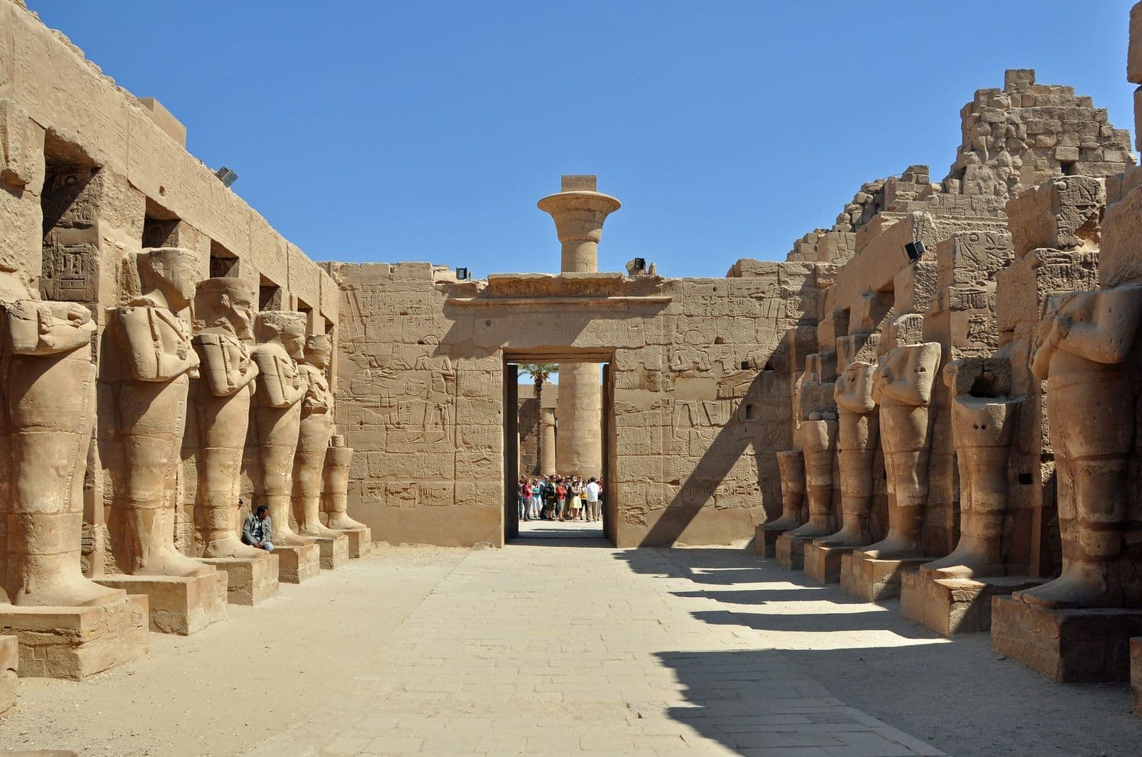 Statues of Ramesses II lining a court inside Karnak Temple
