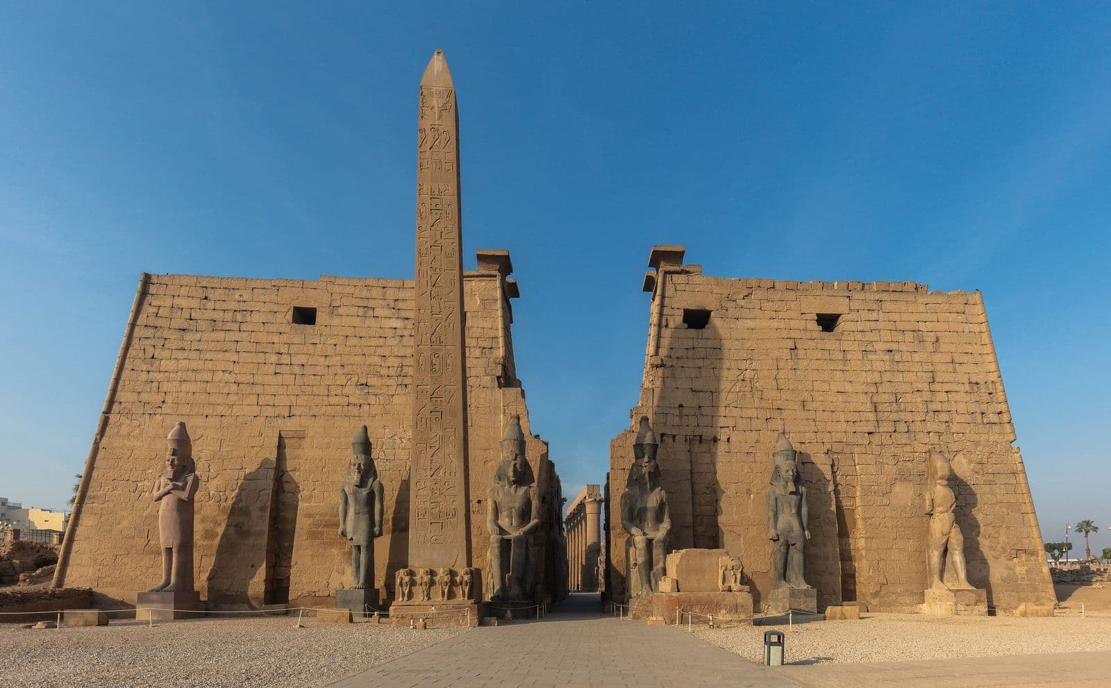 The obelisk and seated statues of Ramesses II at the entrance of Luxor Temple