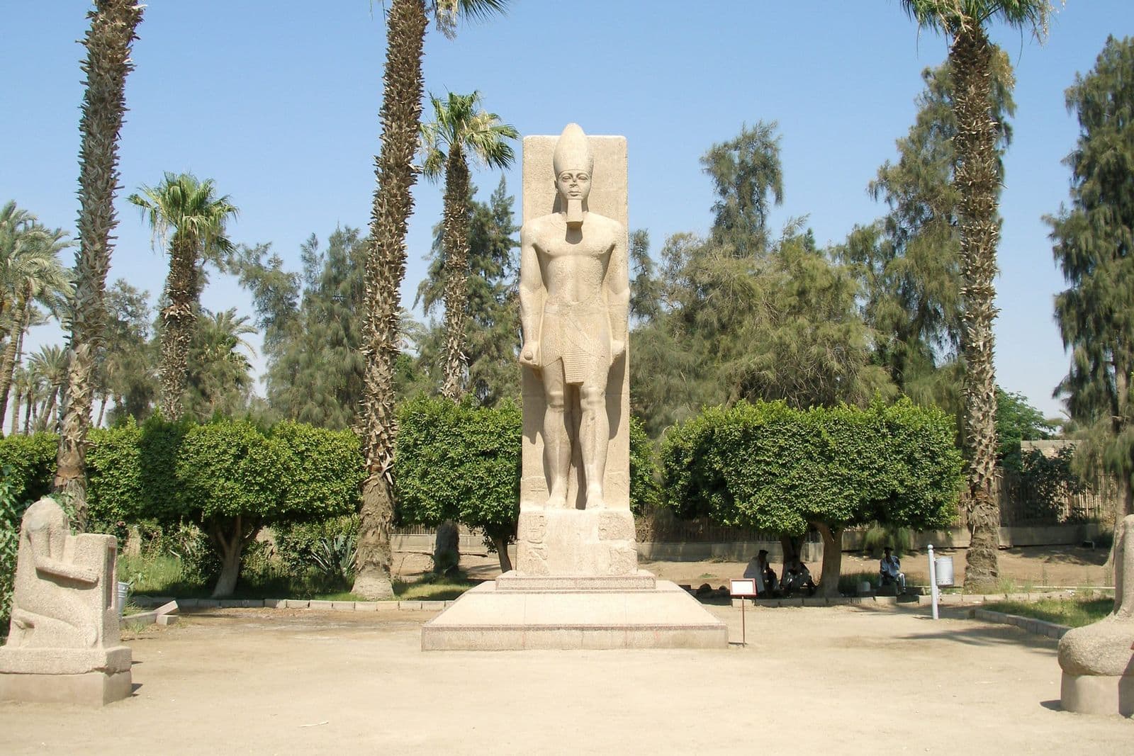 A standing statue of Ramesses II among palms at Memphis