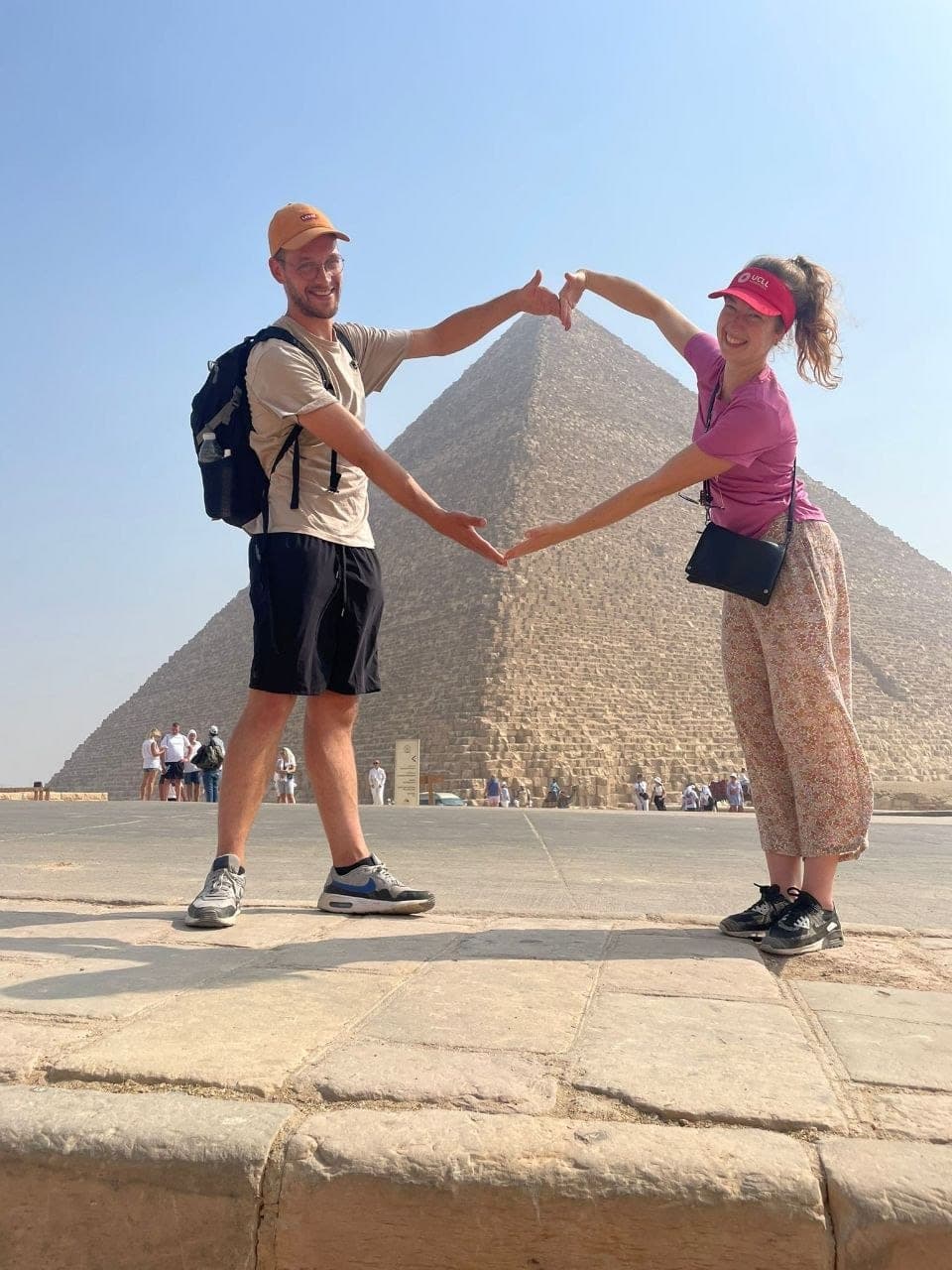 Two travelers making a heart shape around the Great Pyramid