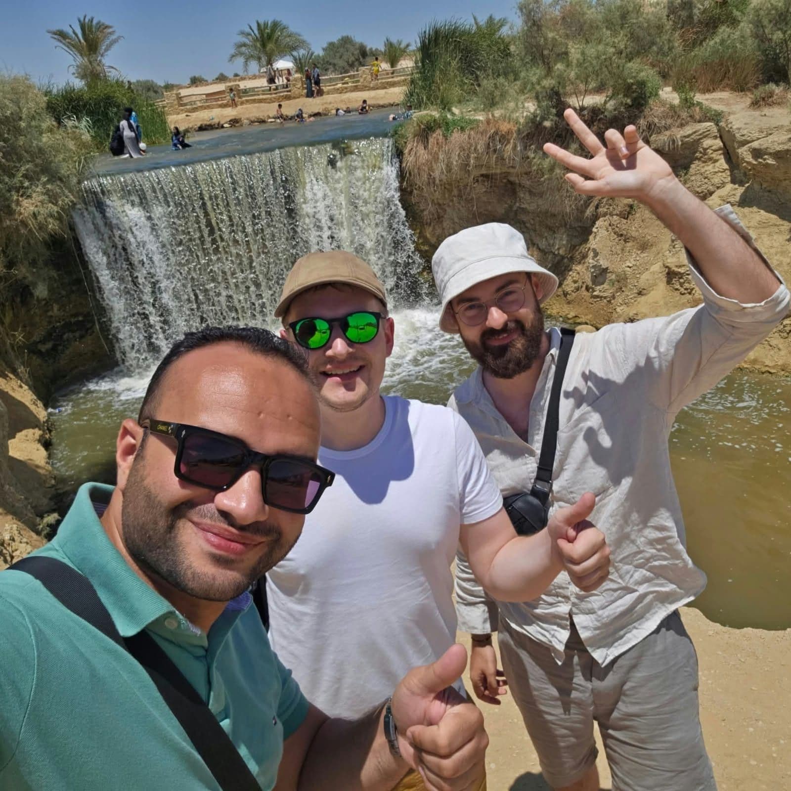 Tarek with two travelers at the Wadi El Rayan waterfalls in Fayoum
