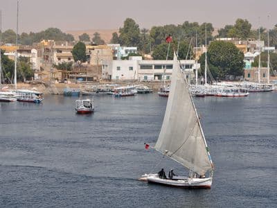 A white-sailed felucca on the Nile at Aswan
