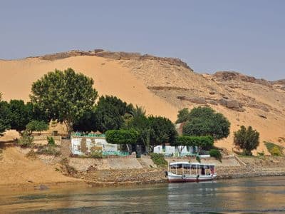Golden dunes and green gardens on the Nile's west bank at Aswan