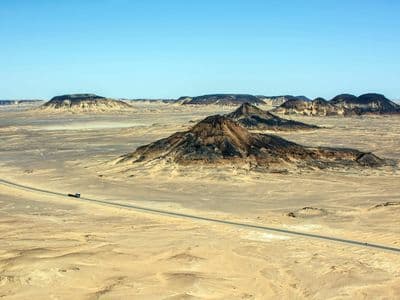 The road through the volcanic hills of the Black Desert near Bahariya