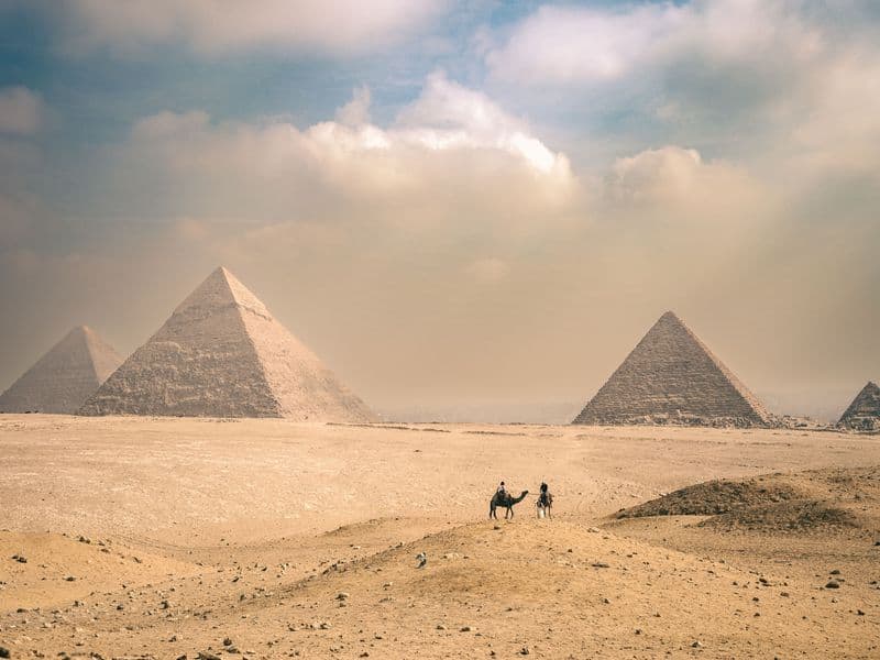 The Great Sphinx with the Pyramid of Khafre behind it on a sunny day