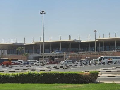 Hurghada International Airport terminal, with transfer coaches and minivans waiting outside