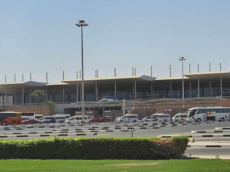 Hurghada International Airport terminal, with transfer coaches and minivans waiting outside