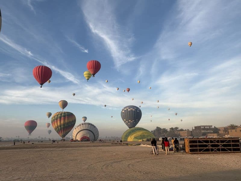 Dozens of hot-air balloons in the morning sky above Luxor