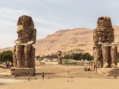 The Colossi of Memnon with the Theban hills behind