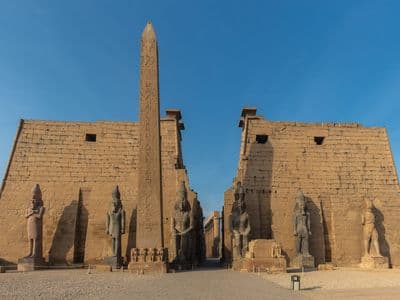 The obelisk and seated statues of Ramesses II at the entrance of Luxor Temple
