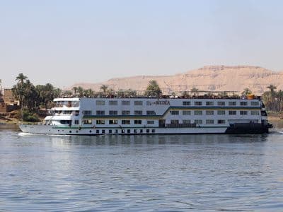 A white Nile cruise ship on the river near Luxor's West Bank