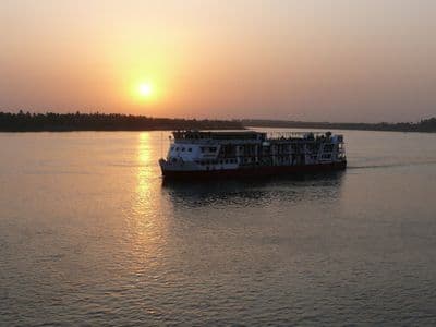 A Nile cruise ship on the river at sunset