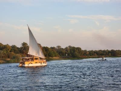 A dahabiya under sail on a calm stretch of the Nile