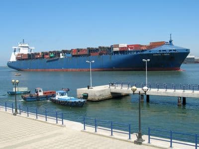 A container ship passing along the Suez Canal at Port Said
