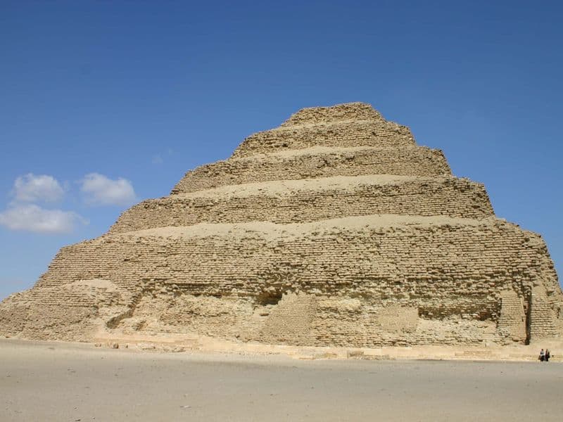 The Step Pyramid of Djoser at Saqqara under a deep blue sky